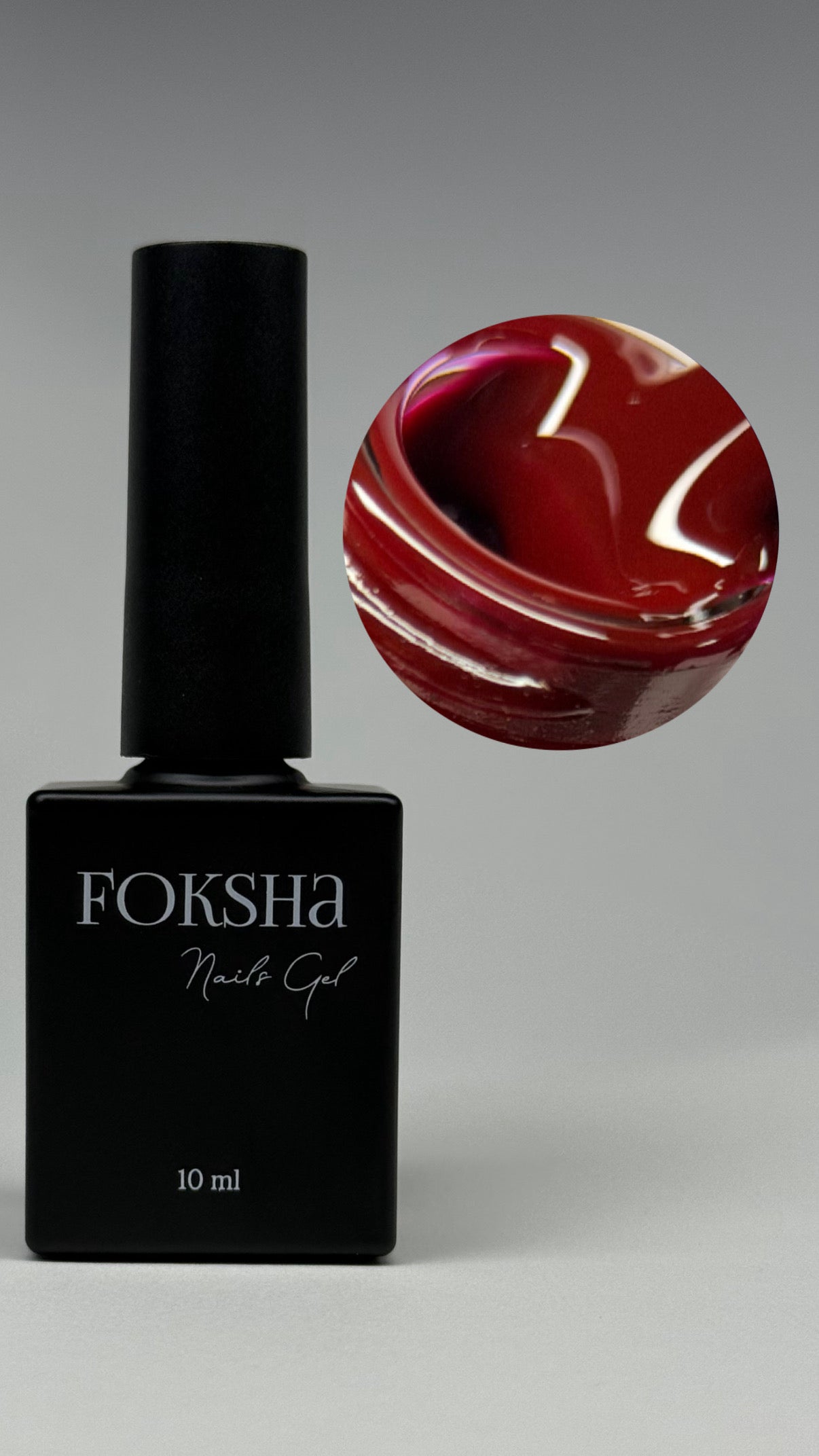 Foksha nail gel bottle with a swatch of red nail polish on a gray background
