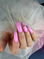 Hand with pink nail polish holding a sheer white fabric