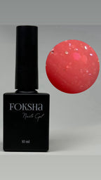 Foksha nail gel polish bottle with a sample of red gel on a gray background