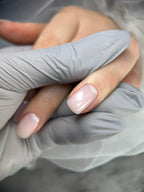 Close-up of a hand wearing a gray glove with a blurred background