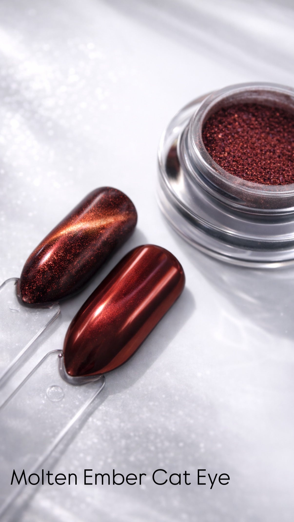Molten Ember Cat Eye nail polish with two applied nails on a white background