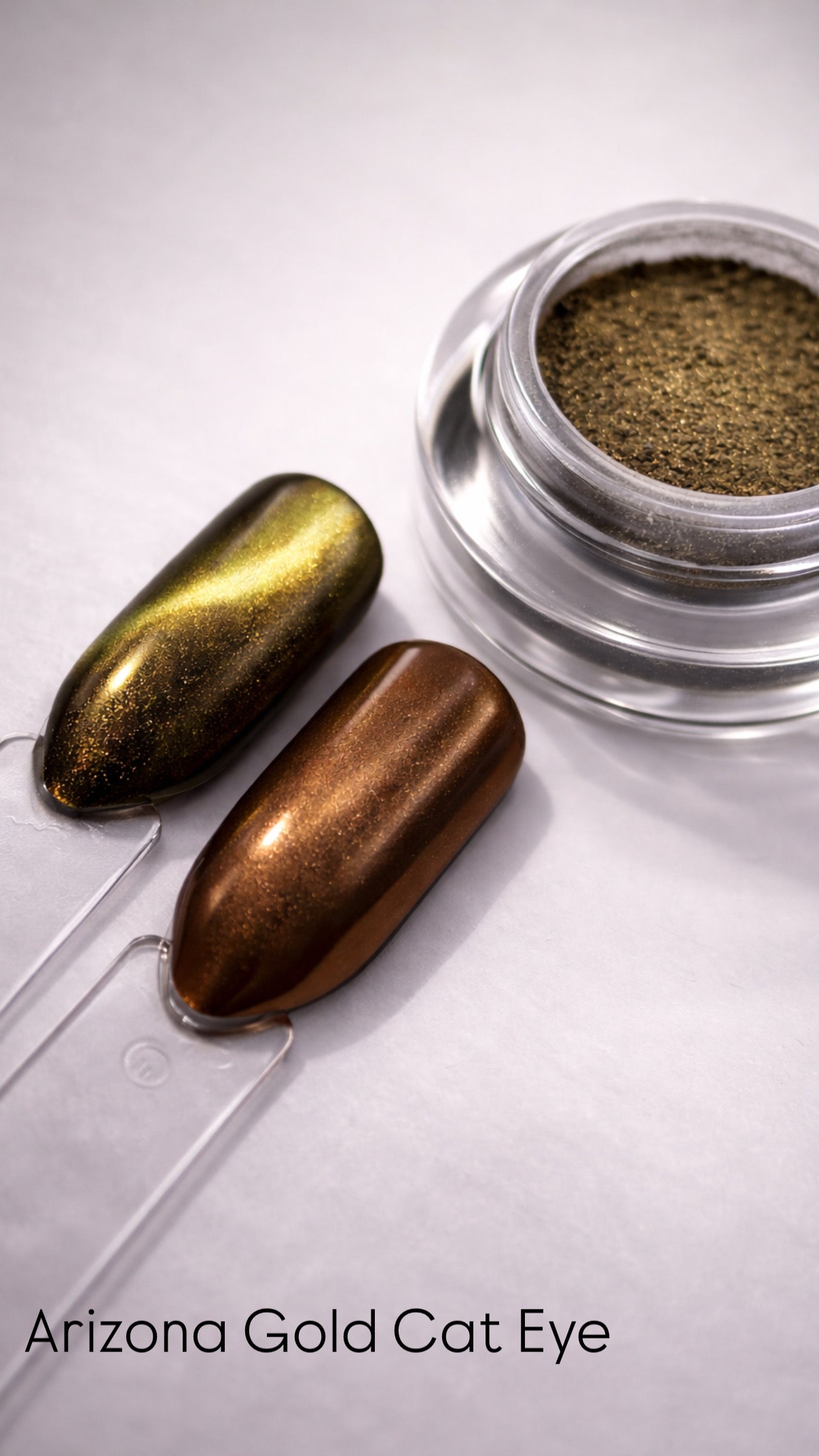 Two metallic nail polishes and a container of powder on a light gray background with 'Arizona Gold Cat Eye' text.