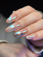 Close-up of a hand with decorative nail art on a blurred background