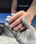 Hand with painted nails using chrome powder