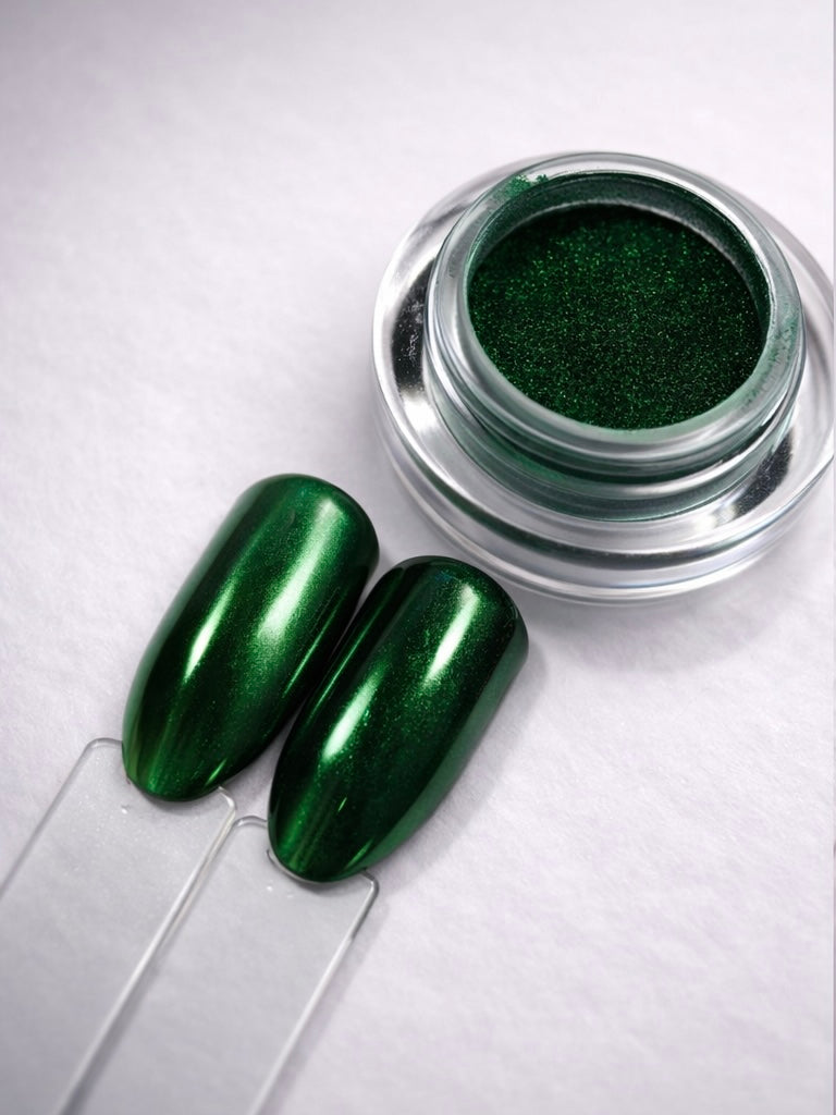 Green nail polish in a jar with two green nails on a white background