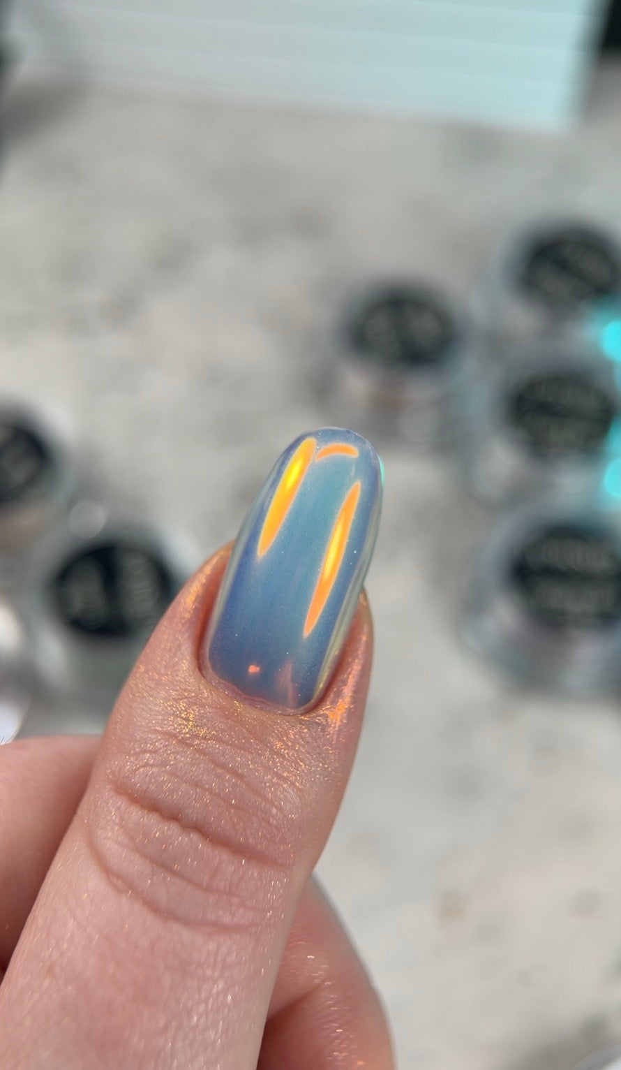 Nail with blue and yellow design on a blurred background