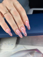 Hand with pink nail polish and a ring, blurred background