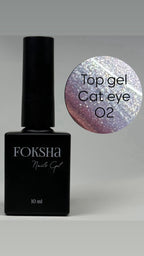 Foksha nail gel polish bottle with a sample of cat eye effect on a gray background
